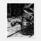 Black and white close up of a cowboy boot with metal spur on wooden floor, western ranch wall art.