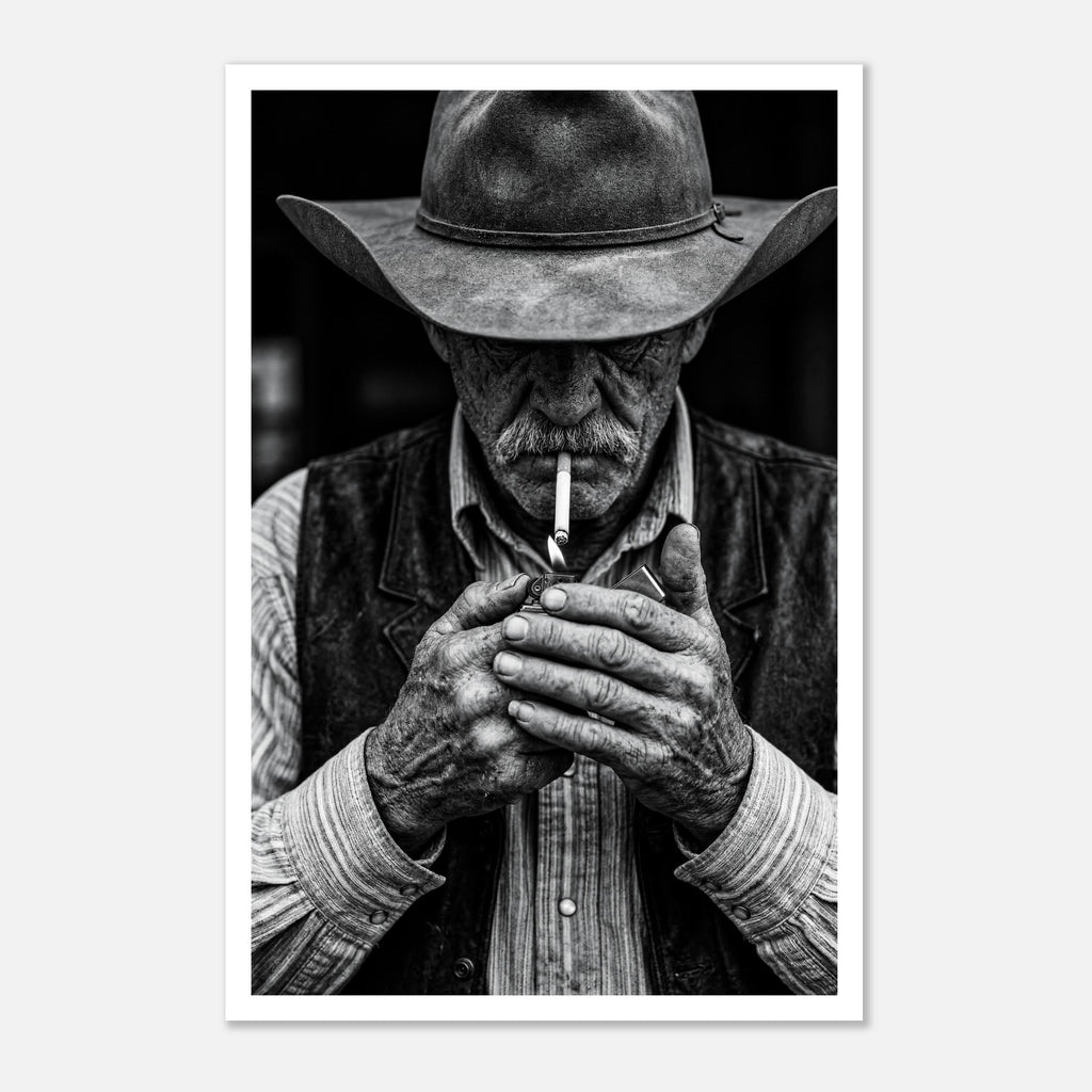 Black and white portrait of a cowboy lighting a cigarette wearing a hat, western wall art.