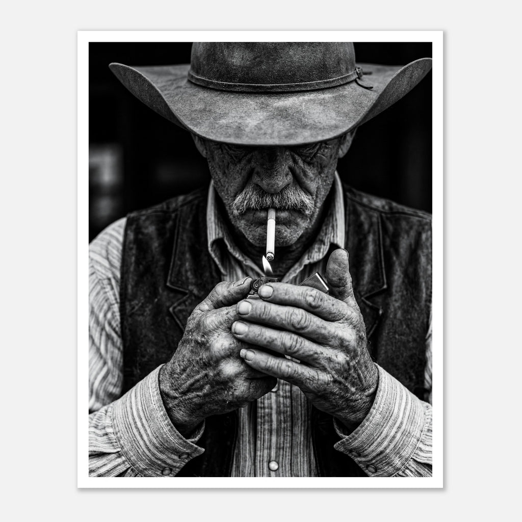 Black and white portrait of a cowboy lighting a cigarette wearing a hat, western wall art.