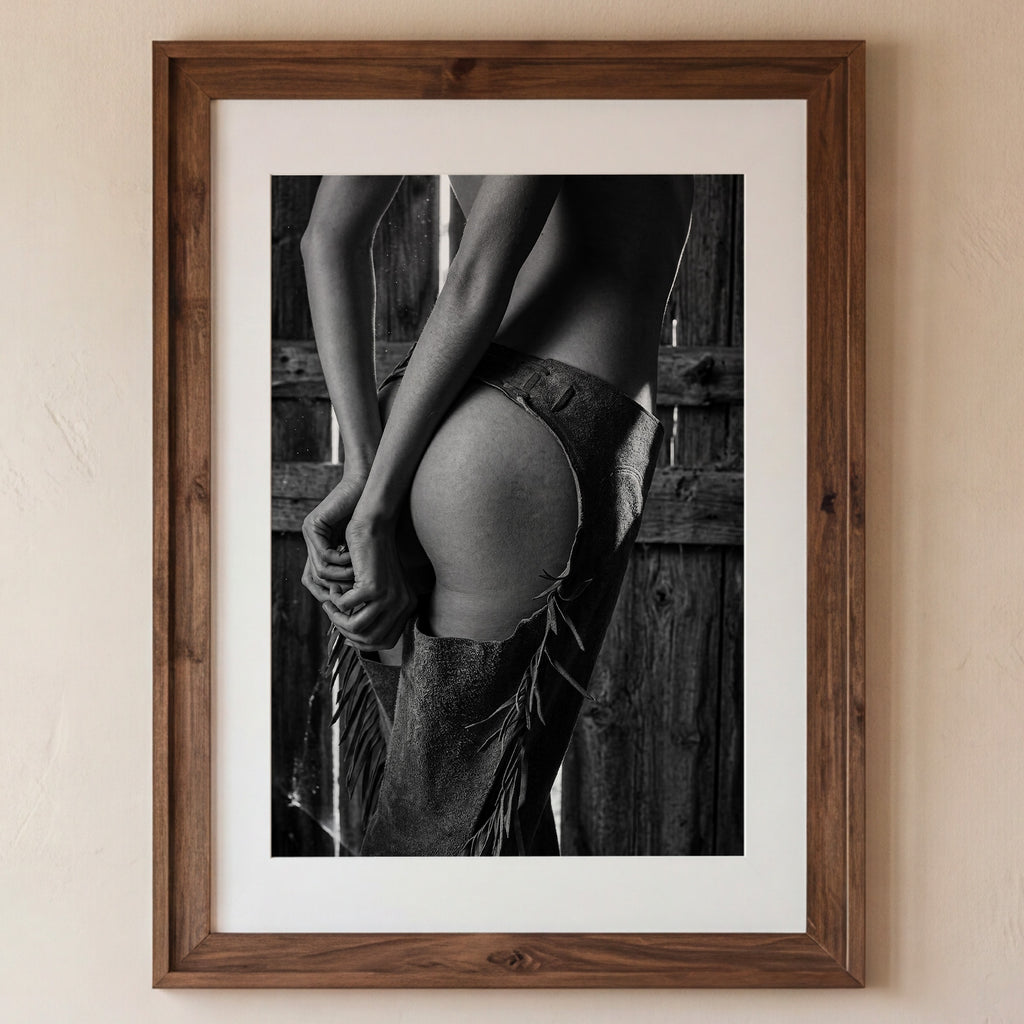 Framed black and white photograph of a person in a rustic setting.