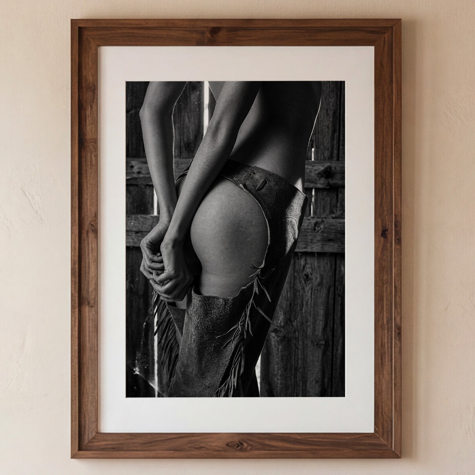 Framed black and white photograph of a person in a rustic setting.