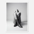 Black and white fine art poster of a seated cowgirl figure wearing classic cowboy boots against a minimalist studio background, creating a dramatic western-inspired composition.