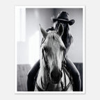 Black and white photograph of a cowgirl riding a horse head on wearing a cowboy hat, western equestrian wall art.