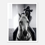 Black and white photograph of a cowgirl riding a horse head on wearing a cowboy hat, western equestrian wall art.