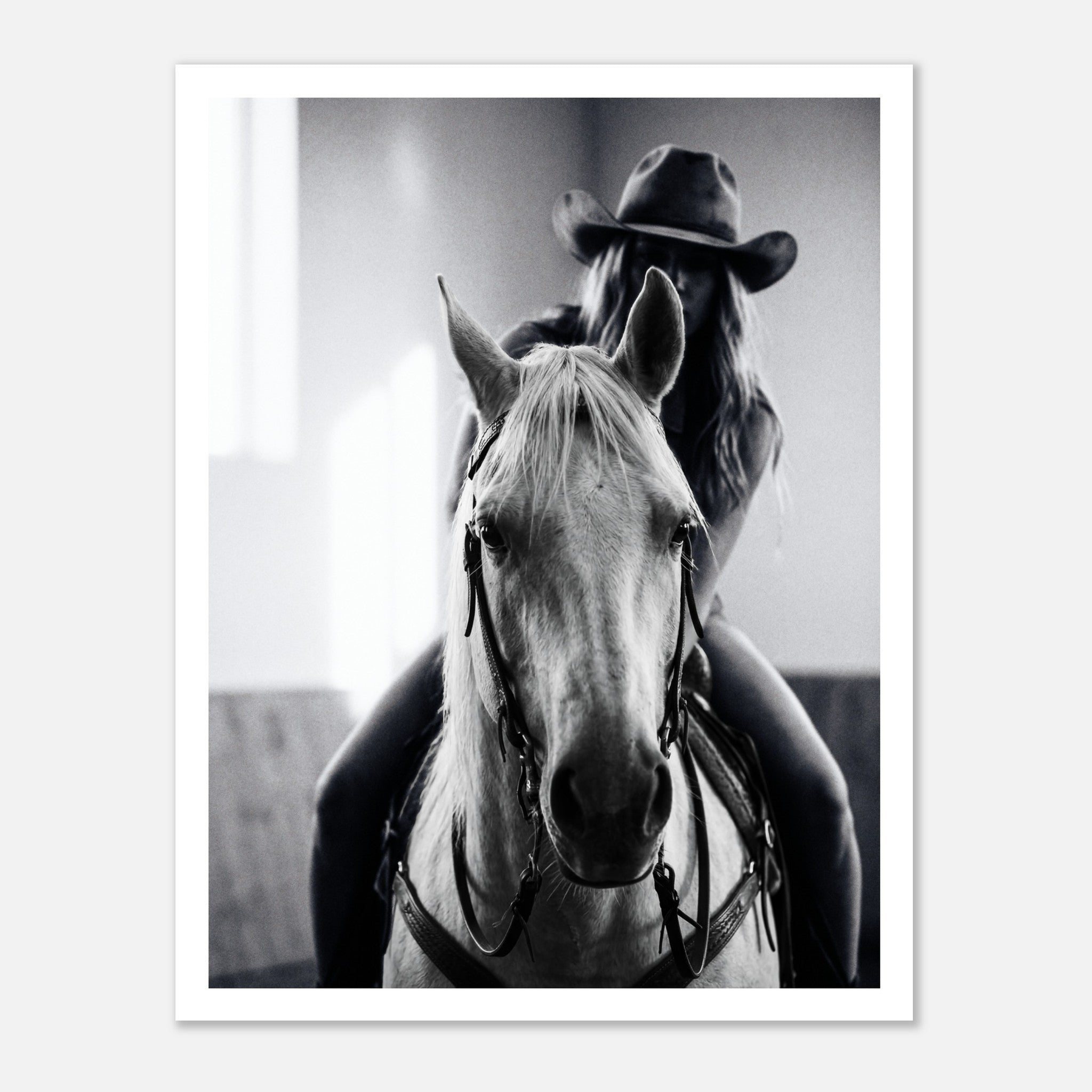 Black and white photograph of a cowgirl riding a horse head on wearing a cowboy hat, western equestrian wall art.