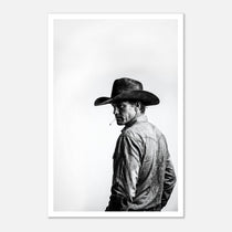 Black and white photograph of a rodeo cowboy wearing a western hat and cigarette, turning toward the camera after competition, western cowboy wall art poster.