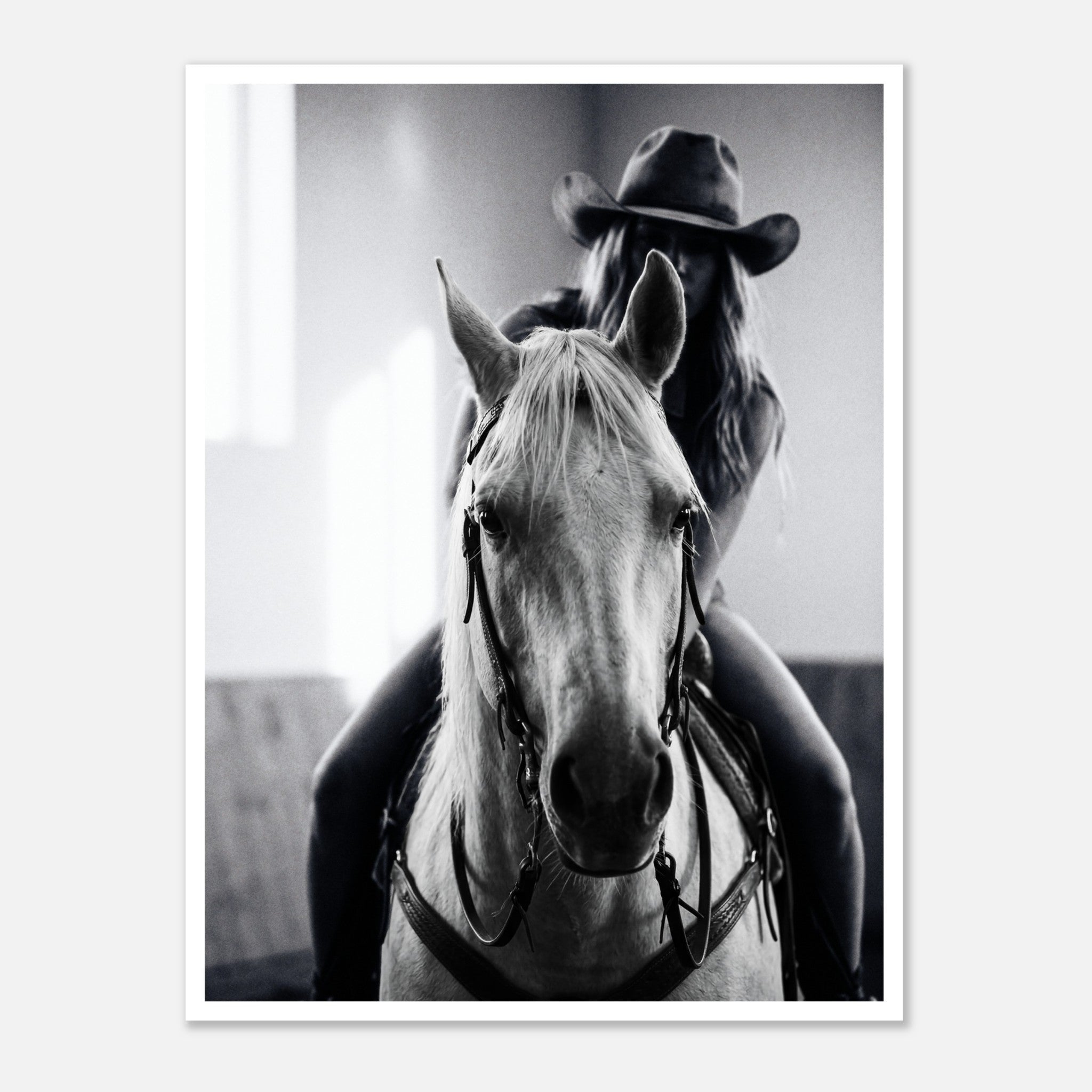 Black and white photograph of a cowgirl riding a horse head on wearing a cowboy hat, western equestrian wall art.