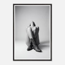 Framed black and white art print of a person sitting with cowboy boots on a plain background