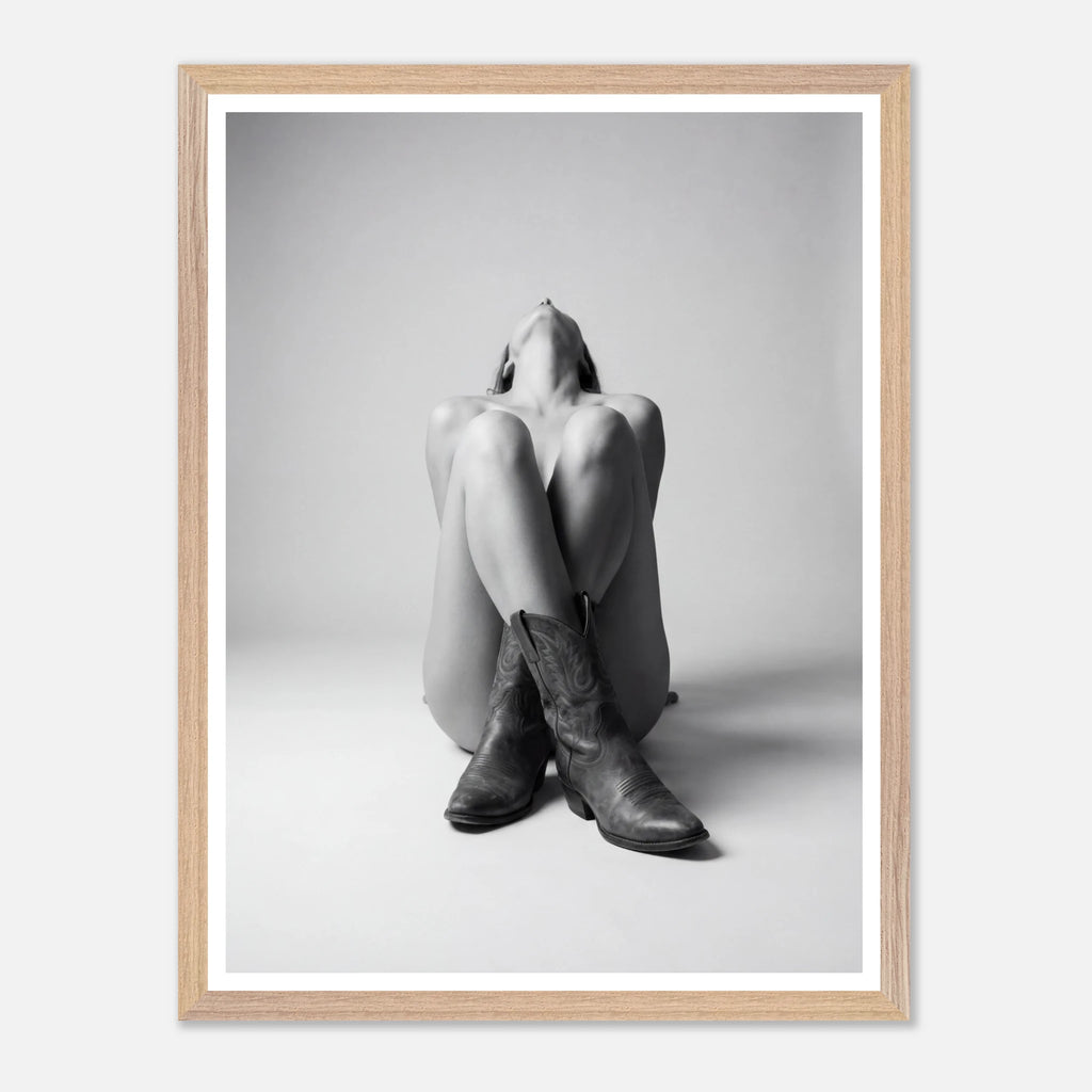Framed black and white art print of a person wearing cowboy boots on a light gray background.