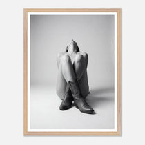 Framed black and white art print of a person wearing cowboy boots on a light gray background.