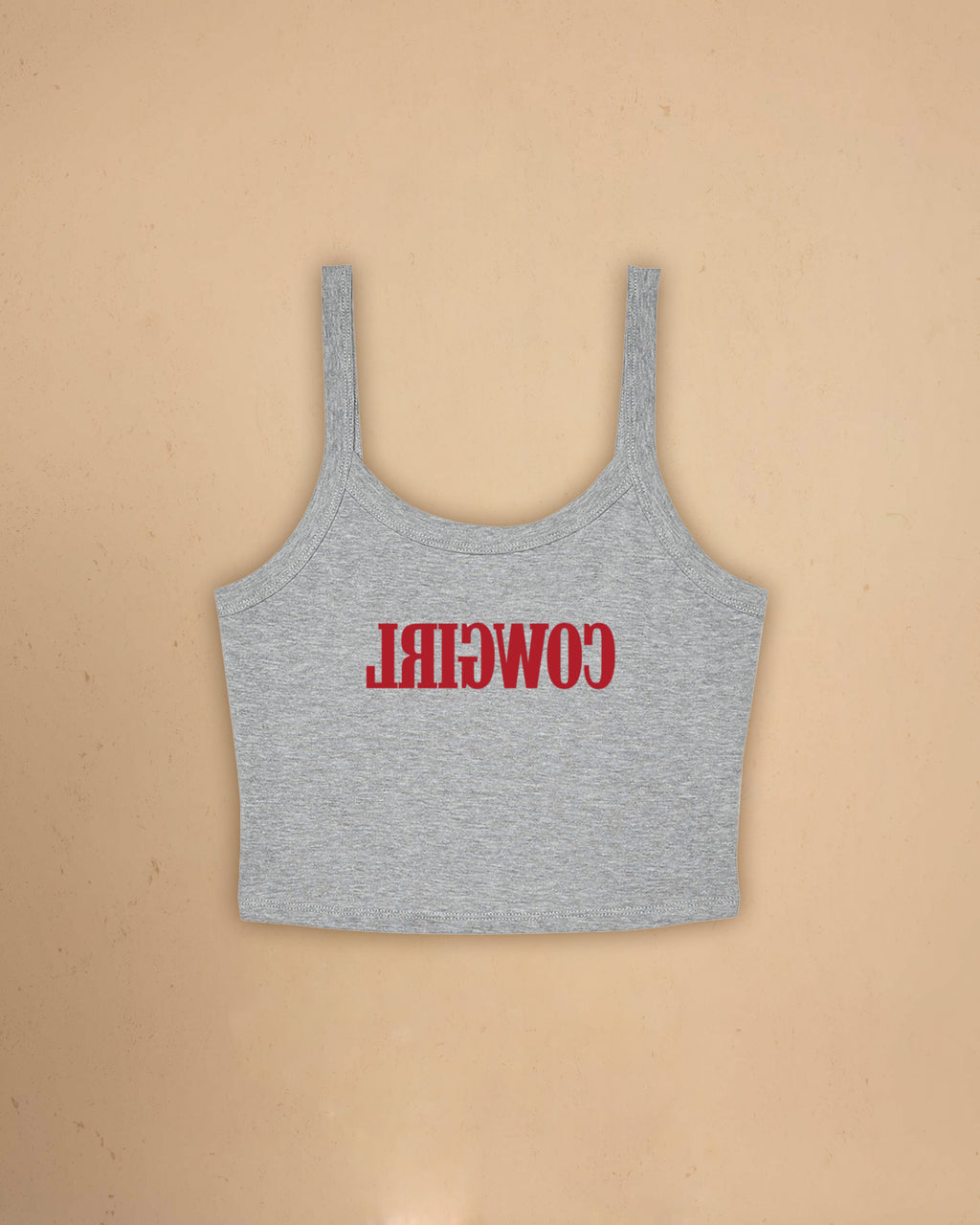 Fitted western-inspired strap tank top featuring mirrored “Cowgirl” typography on the front with a soft micro rib silhouette.
