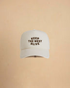 High-profile trucker cap featuring “Keep The West Alive” western typography on the front with mesh back and curved peak.