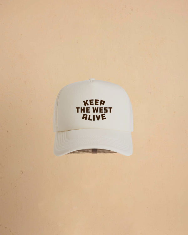 High-profile trucker cap featuring “Keep The West Alive” western typography on the front with mesh back and curved peak.