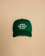 High-profile trucker cap featuring “Keep The West Alive” western typography on the front with mesh back and curved peak.