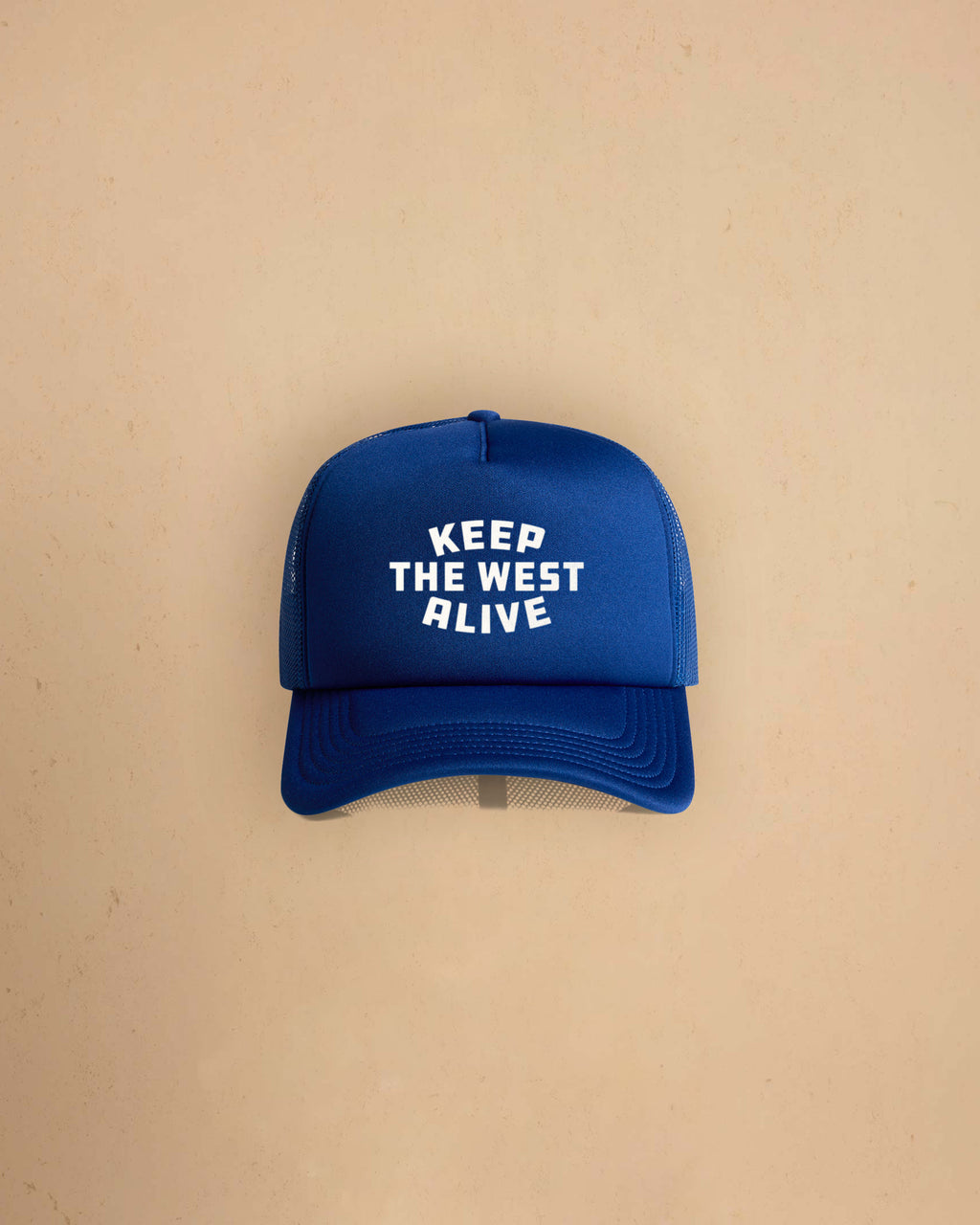 High-profile trucker cap featuring “Keep The West Alive” western typography on the front with mesh back and curved peak.