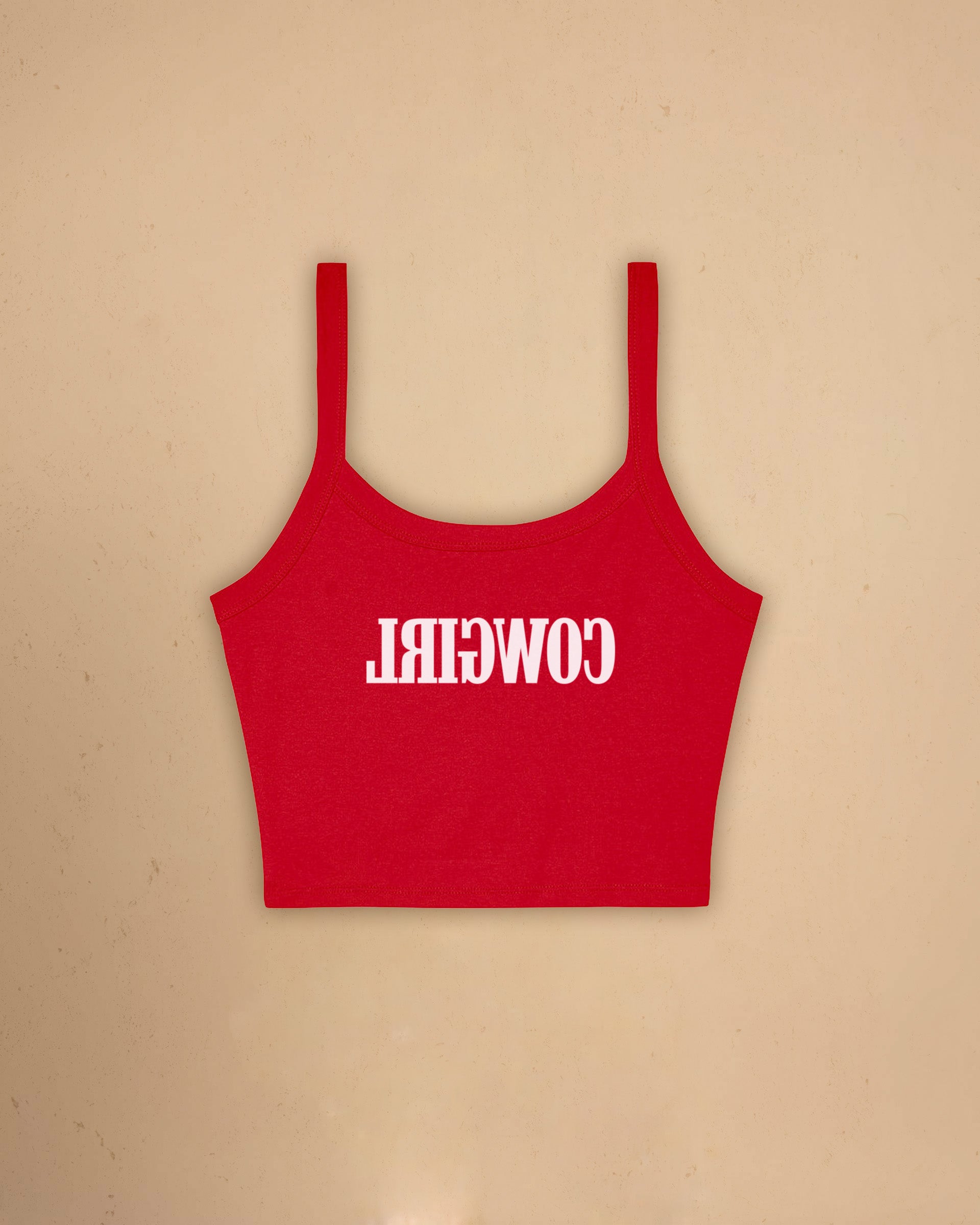 Fitted western-inspired strap tank top featuring mirrored “Cowgirl” typography on the front with a soft micro rib silhouette.