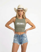 Woman wearing a eucalyptus crop top with red text saying Cowgirl backwards and red high-waisted bikini bottoms on a white background