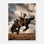 Cowboy riding a bucking horse at sunset with dust and dramatic sky, western rodeo wall art print
