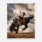 Cowboy riding a bucking horse at sunset with dust and dramatic sky, western rodeo wall art print