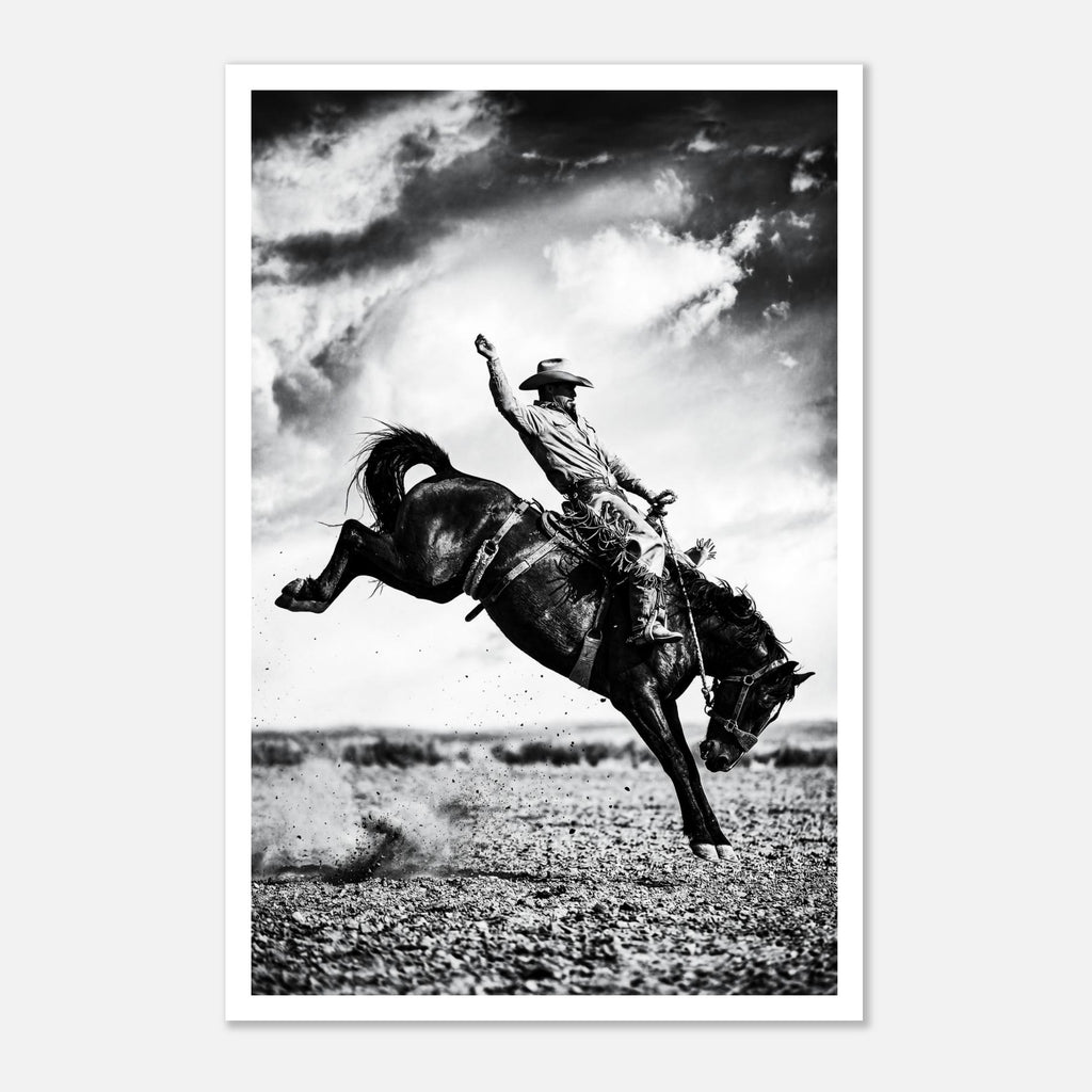 Black and white rodeo wall art showing a cowboy riding a bucking horse in motion.