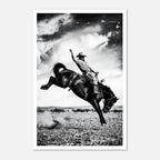 Black and white rodeo wall art showing a cowboy riding a bucking horse in motion.