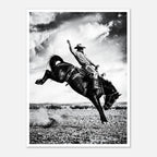 Black and white rodeo wall art showing a cowboy riding a bucking horse in motion.