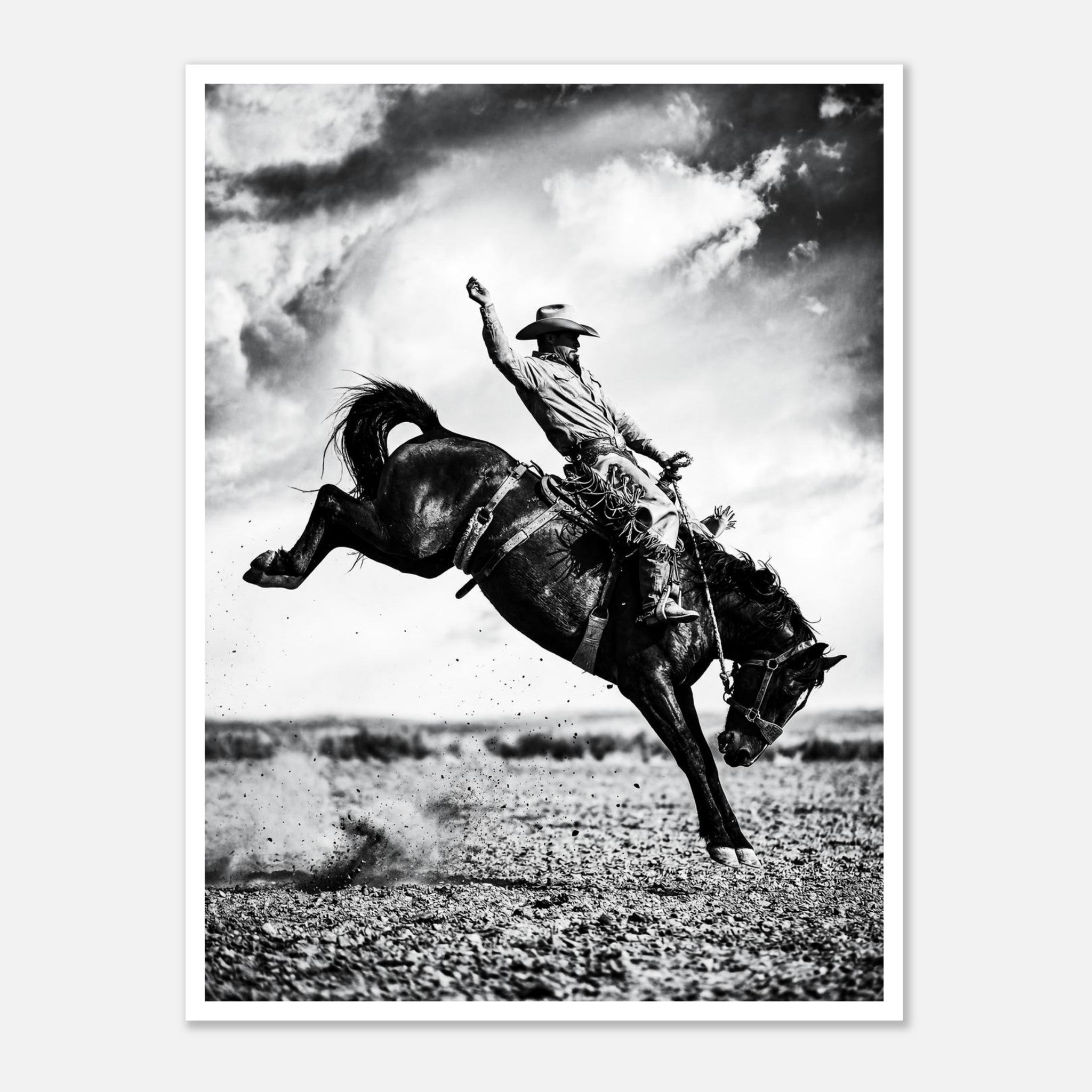 Black and white rodeo wall art showing a cowboy riding a bucking horse in motion.