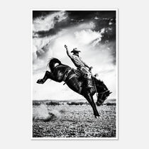 Black and white rodeo wall art showing a cowboy riding a bucking horse in motion.