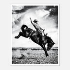 Black and white rodeo wall art showing a cowboy riding a bucking horse in motion.