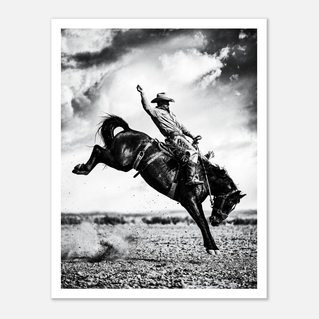 Black and white rodeo wall art showing a cowboy riding a bucking horse in motion.