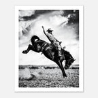 Black and white rodeo wall art showing a cowboy riding a bucking horse in motion.