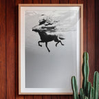 Framed artwork of a horse underwater on a wooden wall with a cactus plant.