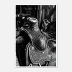 Black and white close up of a western saddle with worn leather and detailed craftsmanship, ranch wall art.
