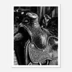 Black and white close up of a western saddle with worn leather and detailed craftsmanship, ranch wall art.
