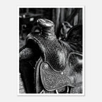 Black and white close up of a western saddle with worn leather and detailed craftsmanship, ranch wall art.