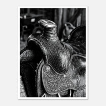 Black and white close up of a western saddle with worn leather and detailed craftsmanship, ranch wall art.