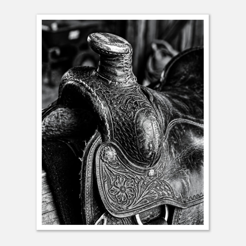 Black and white close up of a western saddle with worn leather and detailed craftsmanship, ranch wall art.