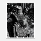Black and white close up of a western saddle with worn leather and detailed craftsmanship, ranch wall art.