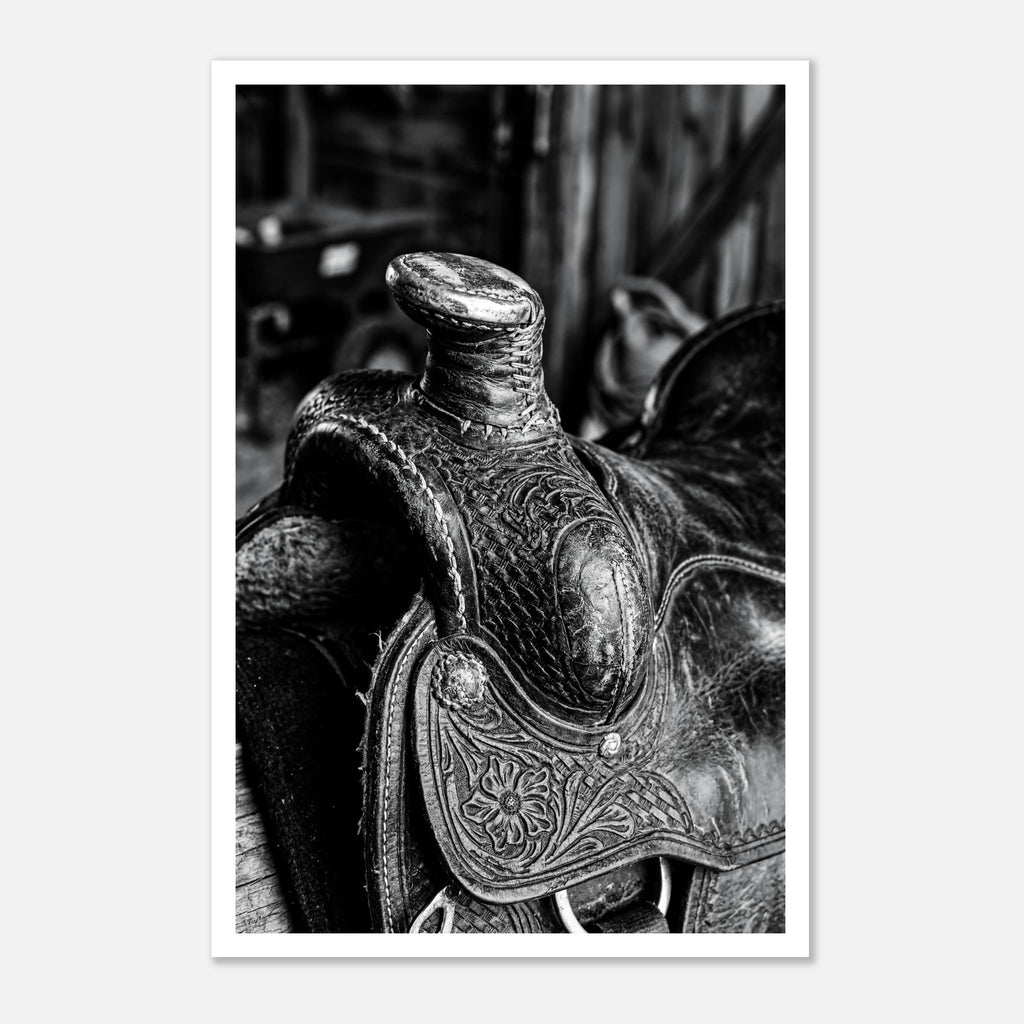 Black and white close up of a western saddle with worn leather and detailed craftsmanship, ranch wall art.
