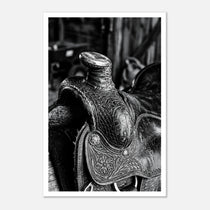 Black and white close up of a western saddle with worn leather and detailed craftsmanship, ranch wall art.