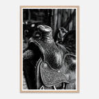 Black and white close up of a western saddle with worn leather and detailed craftsmanship, ranch wall art.