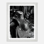 Black and white close up of a western saddle with worn leather and detailed craftsmanship, ranch wall art.