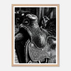 Black and white close up of a western saddle with worn leather and detailed craftsmanship, ranch wall art.