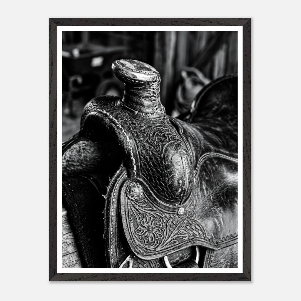 Black and white close up of a western saddle with worn leather and detailed craftsmanship, ranch wall art.