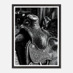 Black and white close up of a western saddle with worn leather and detailed craftsmanship, ranch wall art.