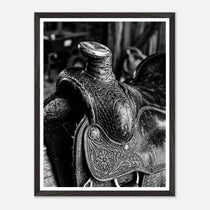 Black and white close up of a western saddle with worn leather and detailed craftsmanship, ranch wall art.