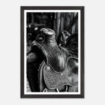 Black and white close up of a western saddle with worn leather and detailed craftsmanship, ranch wall art.