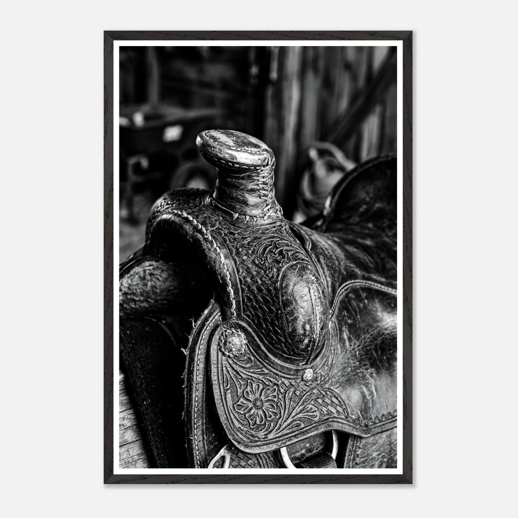 Black and white close up of a western saddle with worn leather and detailed craftsmanship, ranch wall art.