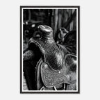 Black and white close up of a western saddle with worn leather and detailed craftsmanship, ranch wall art.