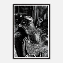Black and white close up of a western saddle with worn leather and detailed craftsmanship, ranch wall art.
